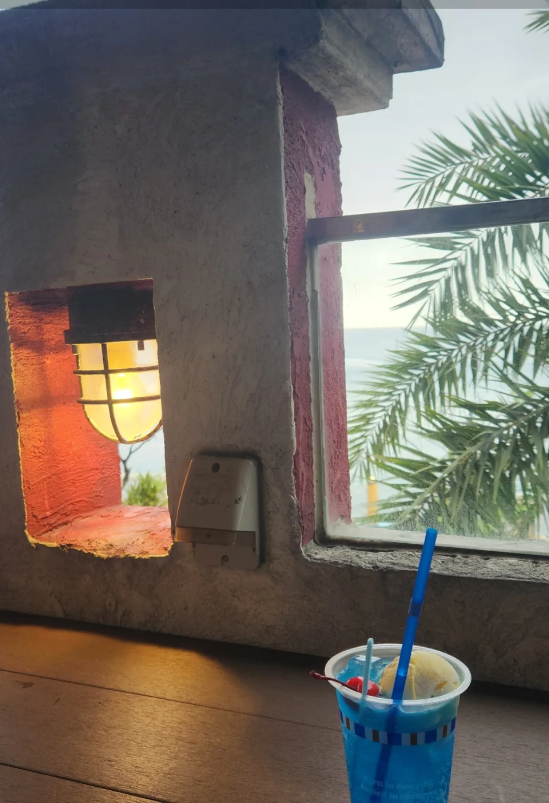 A Blue Seal float set on a windowsill overlooking the sea