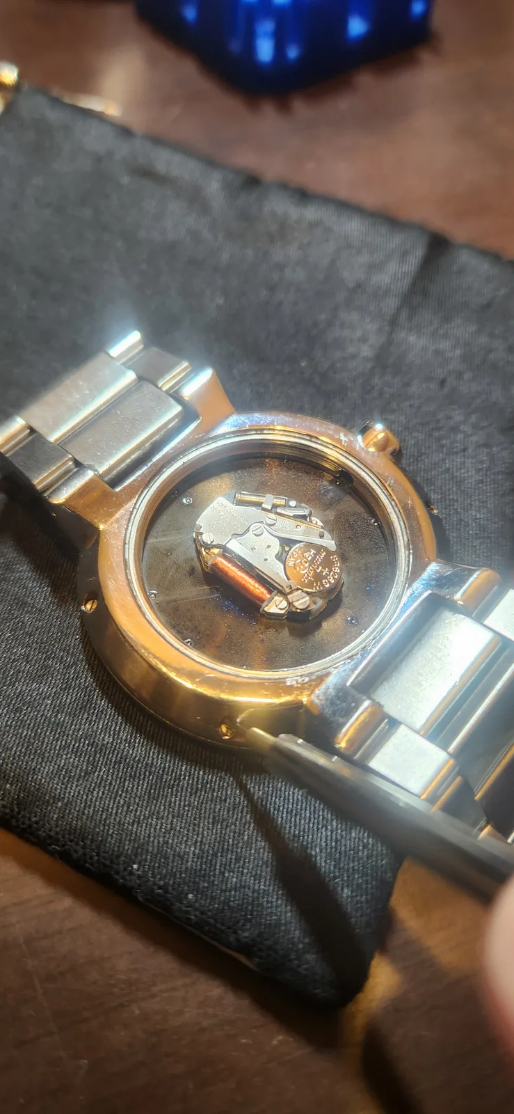 The NIXON THE CAPITAL with its case back open. The movement and button cell are visible